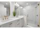 Sleek bathroom with dual sinks, marble walk-in shower, and modern gold fixtures at 101 Ponce De Leon Blvd, Belleair, FL 33756