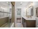 Bright bathroom with double vanity, quartz countertop, and glass shower at 101 Ponce De Leon Blvd, Belleair, FL 33756