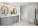 Bathroom offers a modern dual vanity with gray cabinetry, bronze fixtures and natural light at 101 Ponce De Leon Blvd, Belleair, FL 33756