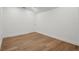 Bedroom with hardwood floors, a white door, and minimal furnishings at 101 Ponce De Leon Blvd, Belleair, FL 33756