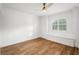 Bright bedroom with hardwood floors, white walls, and a window seat at 101 Ponce De Leon Blvd, Belleair, FL 33756