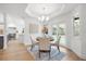 Dining area features modern chandelier, a round table and easy access to the backyard pool at 101 Ponce De Leon Blvd, Belleair, FL 33756