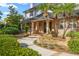 Beautifully landscaped front yard with lush greenery, brick accents, and a welcoming entrance at 101 Ponce De Leon Blvd, Belleair, FL 33756