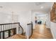 Elegant hallway showcasing hardwood floors and staircase with wrought iron banister and views to the first floor at 101 Ponce De Leon Blvd, Belleair, FL 33756