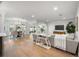 Open concept living room with dining area, hardwood floors, and neutral decor at 101 Ponce De Leon Blvd, Belleair, FL 33756