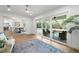Bright living room overlooks the backyard featuring a covered lanai and pool at 101 Ponce De Leon Blvd, Belleair, FL 33756