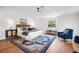 This spacious main bedroom offers natural light, hardwood floors, and comfortable seating at 101 Ponce De Leon Blvd, Belleair, FL 33756