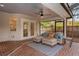 Relaxing screened-in patio featuring comfortable seating, a ceiling fan, and views of the backyard at 101 Ponce De Leon Blvd, Belleair, FL 33756