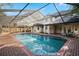 Large screened pool with brick pavers and an outdoor seating area at 101 Ponce De Leon Blvd, Belleair, FL 33756