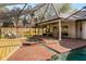 Inviting screened pool area with brick pavers, a hot tub, and lounge chairs at 101 Ponce De Leon Blvd, Belleair, FL 33756