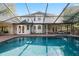 Beautiful backyard pool area with screened enclosure and outdoor seating at 101 Ponce De Leon Blvd, Belleair, FL 33756