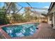Screened-in pool and deck area with brick pavers and lush landscaping at 101 Ponce De Leon Blvd, Belleair, FL 33756