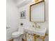 Chic powder room with gold fixtures, pedestal sink, and stylish accents at 101 Ponce De Leon Blvd, Belleair, FL 33756