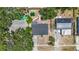 Aerial view showcases the home's layout, including the backyard, nearby street, and surrounding mature trees at 10931 110Th Ave, Seminole, FL 33778