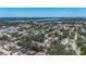Aerial shot reveals a residential area near a picturesque lake and city, perfect for those seeking peaceful community at 10931 110Th Ave, Seminole, FL 33778