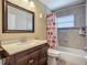 Well-lit bathroom featuring a decorative mirror, vanity with sink, and a tub with a shower at 10931 110Th Ave, Seminole, FL 33778