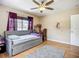 Bright bedroom with hardwood floors, daybed, desk, and ceiling fan at 10931 110Th Ave, Seminole, FL 33778