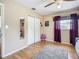 Bedroom featuring hardwood floors, closet, a mirror, and natural light from the window at 10931 110Th Ave, Seminole, FL 33778