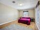 Well-lit bedroom boasts hardwood floors, neutral color scheme, and bedside tables at 10931 110Th Ave, Seminole, FL 33778