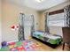 Inviting bedroom features hardwood floors, two windows, and decor at 10931 110Th Ave, Largo, FL 33778