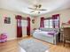 Sunlit bedroom featuring hardwood floors, complemented by a comfortable daybed and stylish window treatments at 10931 110Th Ave, Seminole, FL 33778