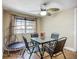 Inviting dining area featuring a ceiling fan, natural light, and a four-seat glass-top table at 10931 110Th Ave, Seminole, FL 33778