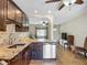 Modern kitchen featuring granite countertops and stainless steel appliances, seamlessly connecting to the living area at 10931 110Th Ave, Seminole, FL 33778