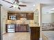 An eat-in kitchen featuring granite countertops, stainless steel appliances, and dark cabinets at 10931 110Th Ave, Seminole, FL 33778