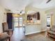 Open-concept view of a modern kitchen and a cozy living room with neutral paint and floors at 10931 110Th Ave, Seminole, FL 33778