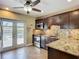 Modern kitchen featuring stainless steel appliances, granite countertops, and dark wood cabinetry at 10931 110Th Ave, Seminole, FL 33778