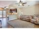 Comfortable living room featuring tile floors, tropical print seating, and a ceiling fan at 10931 110Th Ave, Seminole, FL 33778