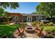 Inviting backyard featuring a firepit, dining area, lush landscaping, and relaxing hot tub at 10931 110Th Ave, Seminole, FL 33778