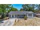 Quaint home with a well-maintained lawn and stone accents, offering curb appeal at 10931 110Th Ave, Seminole, FL 33778