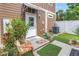 Charming backyard space with artificial turf, patio area, and lush landscaping at 1116 Martin Luther King Jr Ave, Dunedin, FL 34698