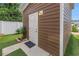 Exterior view of back entrance leading to artificial turf with small landscaping and privacy fence at 1116 Martin Luther King Jr Ave, Dunedin, FL 34698