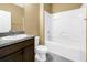 Clean bathroom features a tub and dark wood vanity at 1116 Martin Luther King Jr Ave, Dunedin, FL 34698