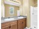 Bathroom featuring a double sink vanity with ample counter space, a large mirror, and a walk-in shower at 1116 Martin Luther King Jr Ave, Dunedin, FL 34698