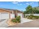 Exterior showcasing townhomes with attached garages, landscaped yards, and inviting curb appeal at 1116 Martin Luther King Jr Ave, Dunedin, FL 34698