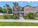 Beautiful townhome with palm trees, landscaped yard, and inviting front entrance at 1116 Martin Luther King Jr Ave, Dunedin, FL 34698