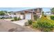 Exterior view of townhomes featuring attached garages, landscaped yards, and well-maintained surroundings at 1116 Martin Luther King Jr Ave, Dunedin, FL 34698