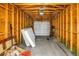 Unfinished garage interior with wood studs, concrete floor, and a white garage door at 1116 Martin Luther King Jr Ave, Dunedin, FL 34698
