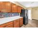 Contemporary kitchen features stainless steel refrigerator and unique backsplash at 1116 Martin Luther King Jr Ave, Dunedin, FL 34698