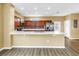 Well-equipped kitchen featuring ample counter space, stainless steel fridge and classic wood cabinets at 1116 Martin Luther King Jr Ave, Dunedin, FL 34698