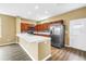 Charming kitchen with stainless steel appliances, breakfast bar, and wood cabinetry at 1116 Martin Luther King Jr Ave, Dunedin, FL 34698