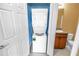 Convenient laundry area with a stackable washer and dryer unit next to vanity with sink and toilet at 1116 Martin Luther King Jr Ave, Dunedin, FL 34698