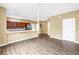Bright living area with vinyl floors, modern light fixture, and a connecting kitchen at 1116 Martin Luther King Jr Ave, Dunedin, FL 34698