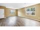 Open-concept living room with neutral paint, great natural light and modern flooring at 1116 Martin Luther King Jr Ave, Dunedin, FL 34698