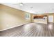 Open-concept living area with vinyl floors, a ceiling fan, and a connecting kitchen at 1116 Martin Luther King Jr Ave, Dunedin, FL 34698