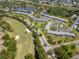 Aerial view of condo community near golf course, lake, and lush landscaping at 112 W Cypress Ct, Oldsmar, FL 34677