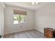 Bright and airy bedroom with a large window overlooking the community and neutral wall color at 112 W Cypress Ct, Oldsmar, FL 34677